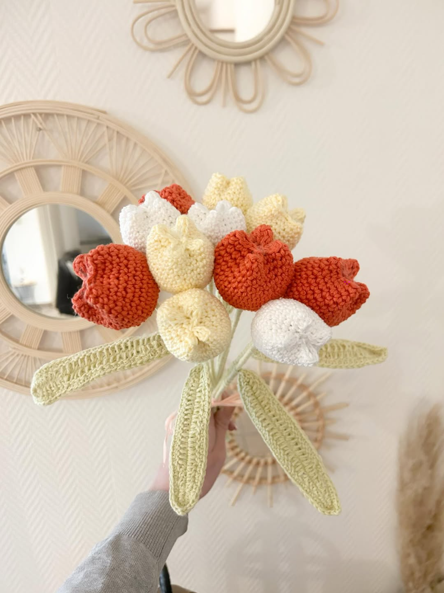 Bouquet rose, blanc et bleu au crochet présenté dans un panier